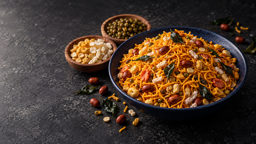 WelNuts Ipoh Mixture with moong dhal and crisp ingredients on a dark stone table
